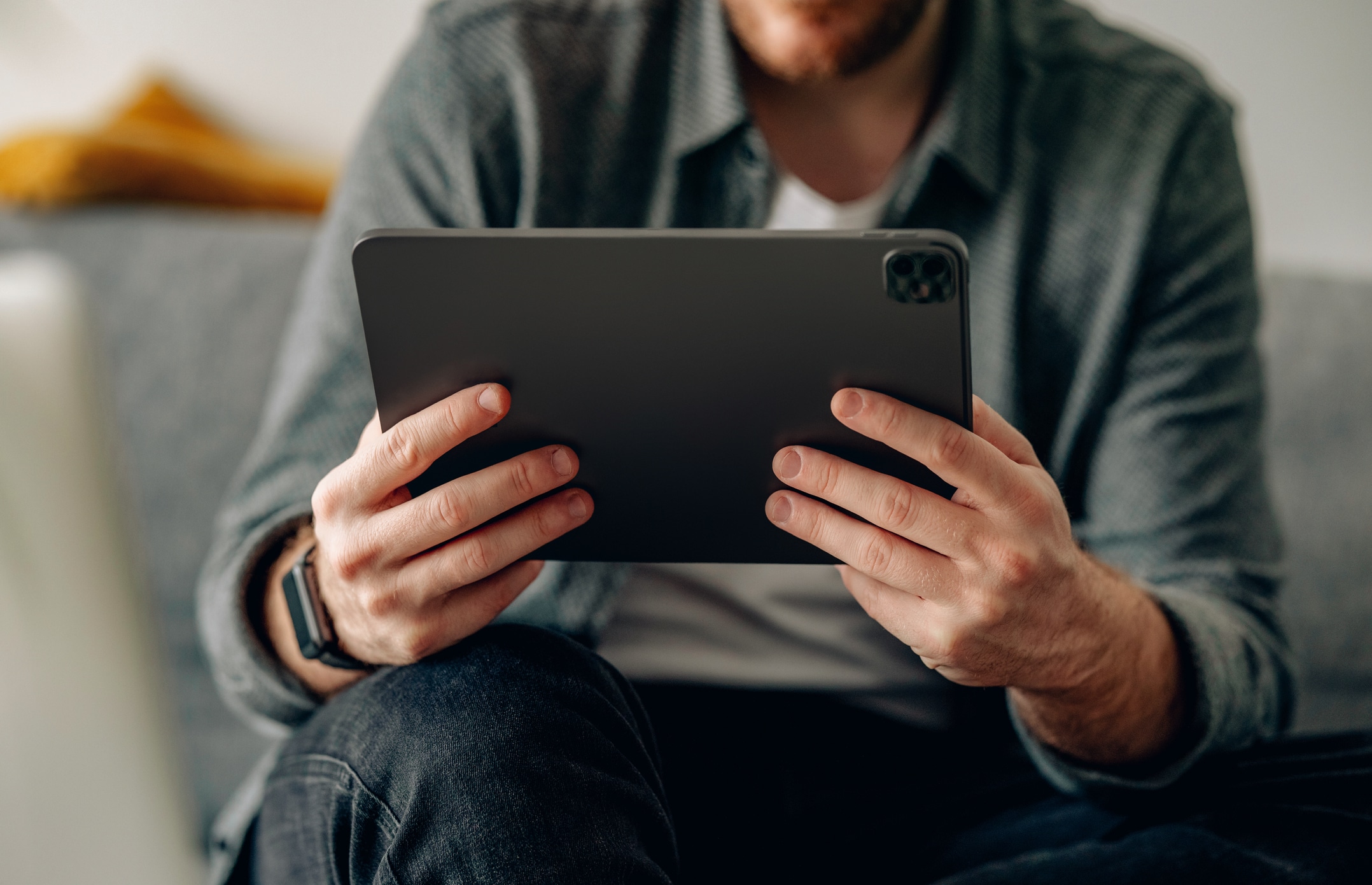 Man looking at online mental health resources on ipad