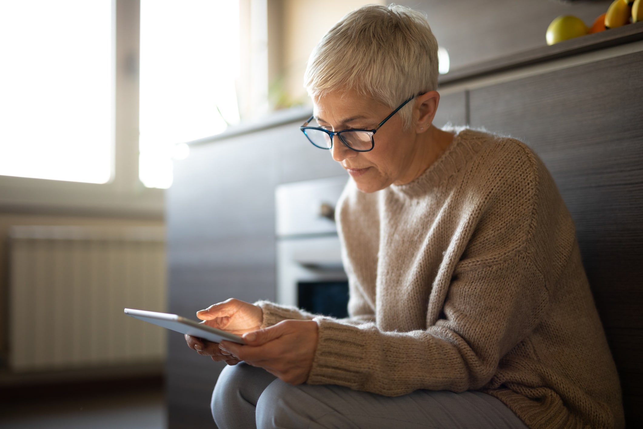 Woman looking at ipad for resources about meth abuse