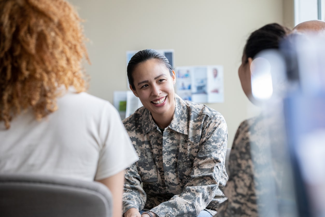 female military in therapy smiling